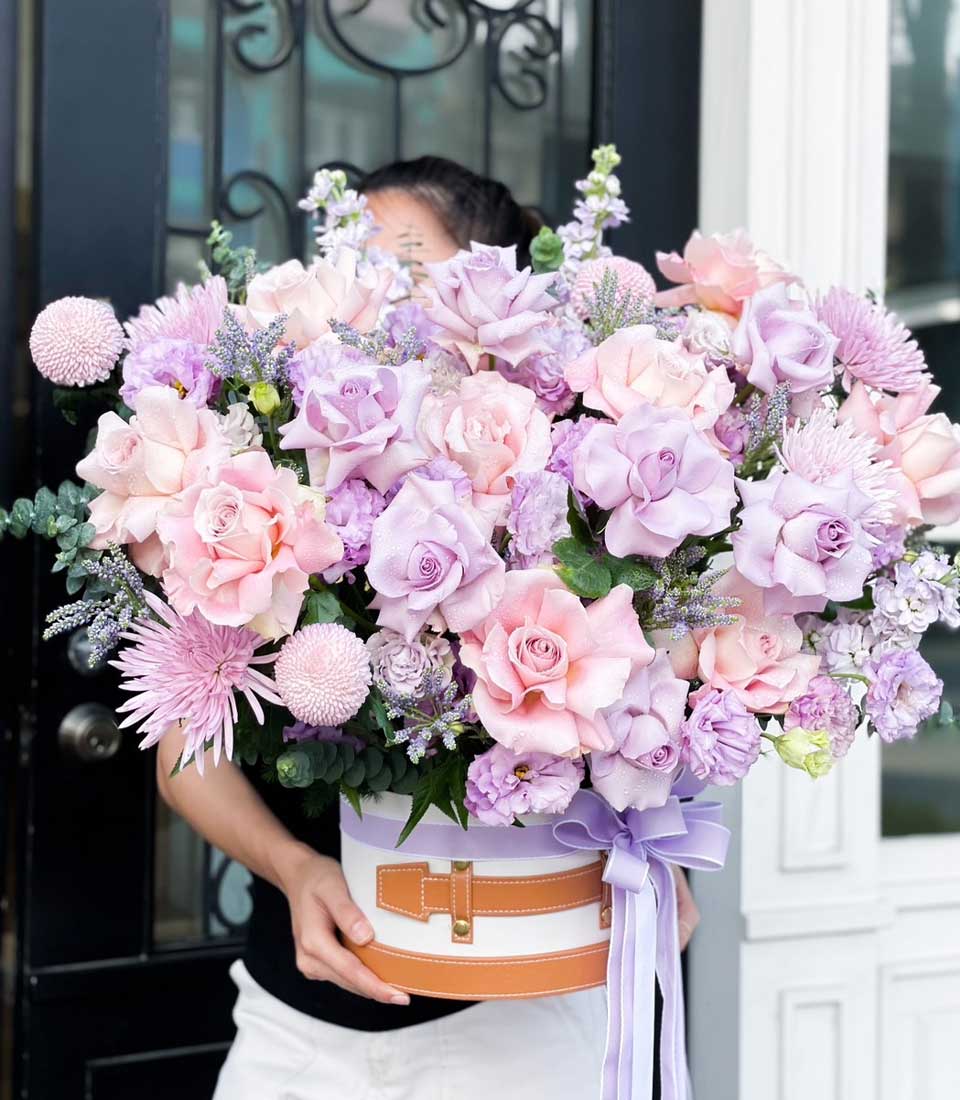 Pink and lavender rose arrangement in luxury round flower box with leather strap, birthday gift
