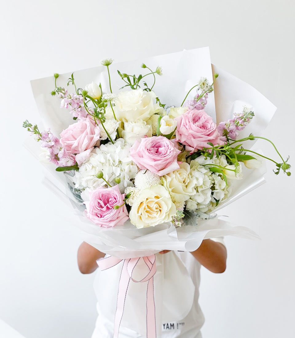 Pink and white rose bouquet with hydrangeas and tulips, tied with silk ribbon for birthday gifting