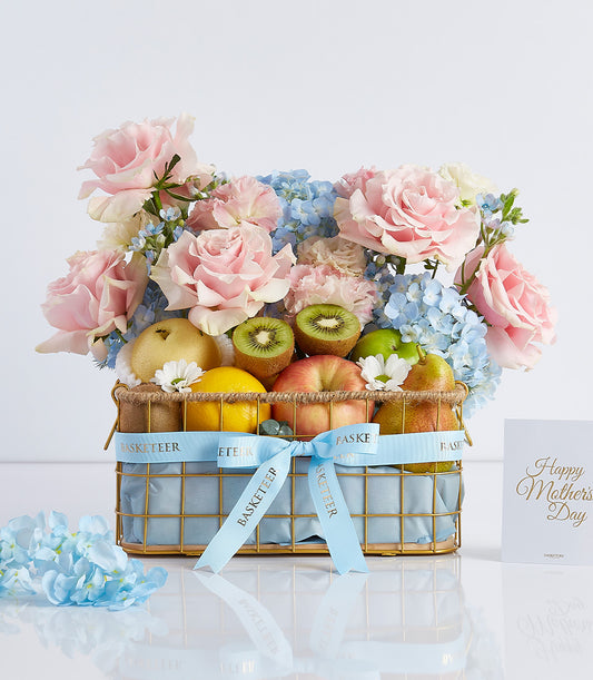 Premium rose and fresh fruit gift basket with light pink blooms and seasonal produce for celebrations
