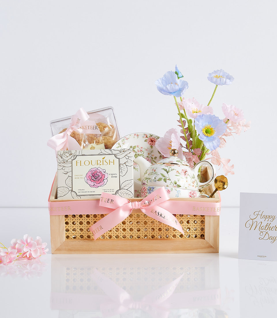 Luxury Mother's Day gift basket with English rose tea, cookies, floral teapot set, and pink ribbon in wooden crate