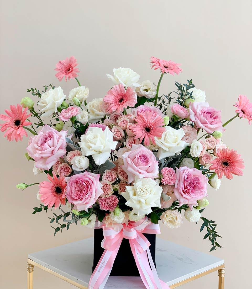 Pink and white roses with gerbera daisies in luxury black box, graduation congratulations flowers
