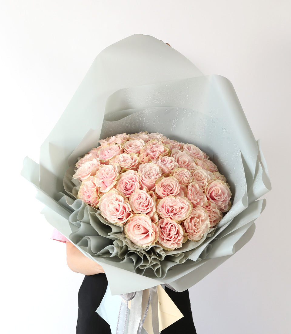 Light pink rose bouquet with 50 stems, grey layered wrap and silver ribbon, anniversary gift
