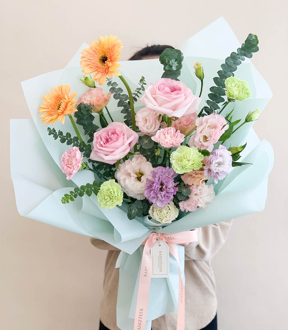 Pastel Dream floral bouquet with pink roses, gerbera daisies, and lisianthus in light blue wrapped gift