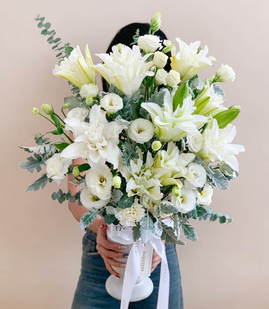 Elegant white lily vase arrangement with dahlias and roses, tied with ribbon for birthday celebrations