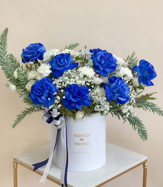 Blue rose and white carnation graduation flowers in premium white box with navy ribbon