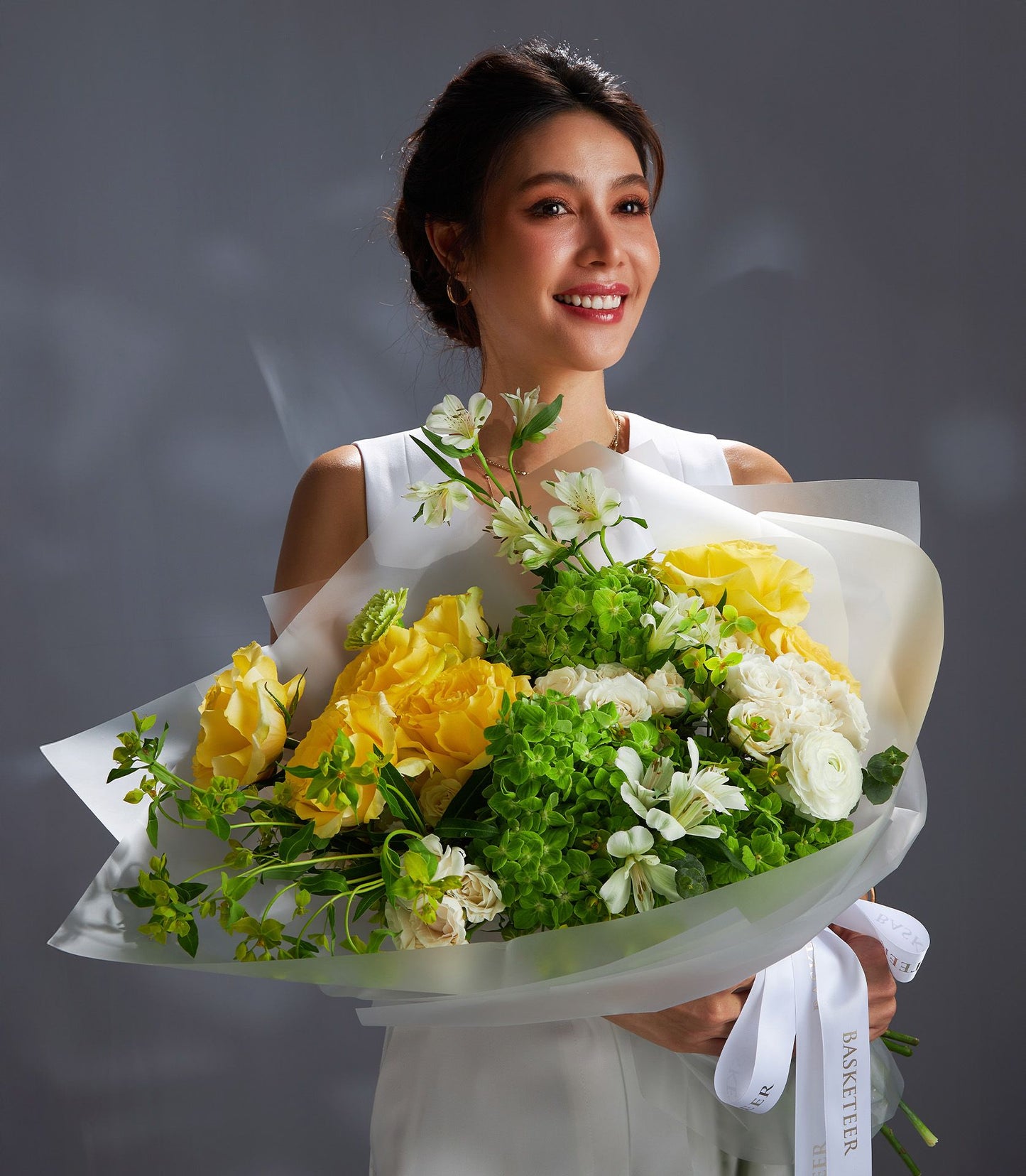 Fresh yellow roses and green hydrangea bouquet with white ranunculus, premium Ecuador-sourced flowers wrapped in luxury paper