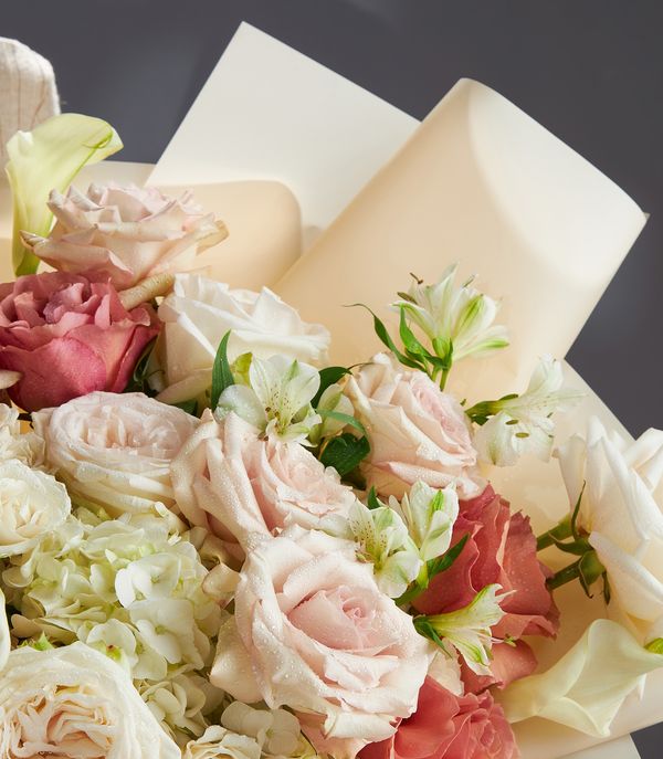 Luxe white and blush rose bouquet with hydrangeas and calla lilies, cream-wrapped gift flowers