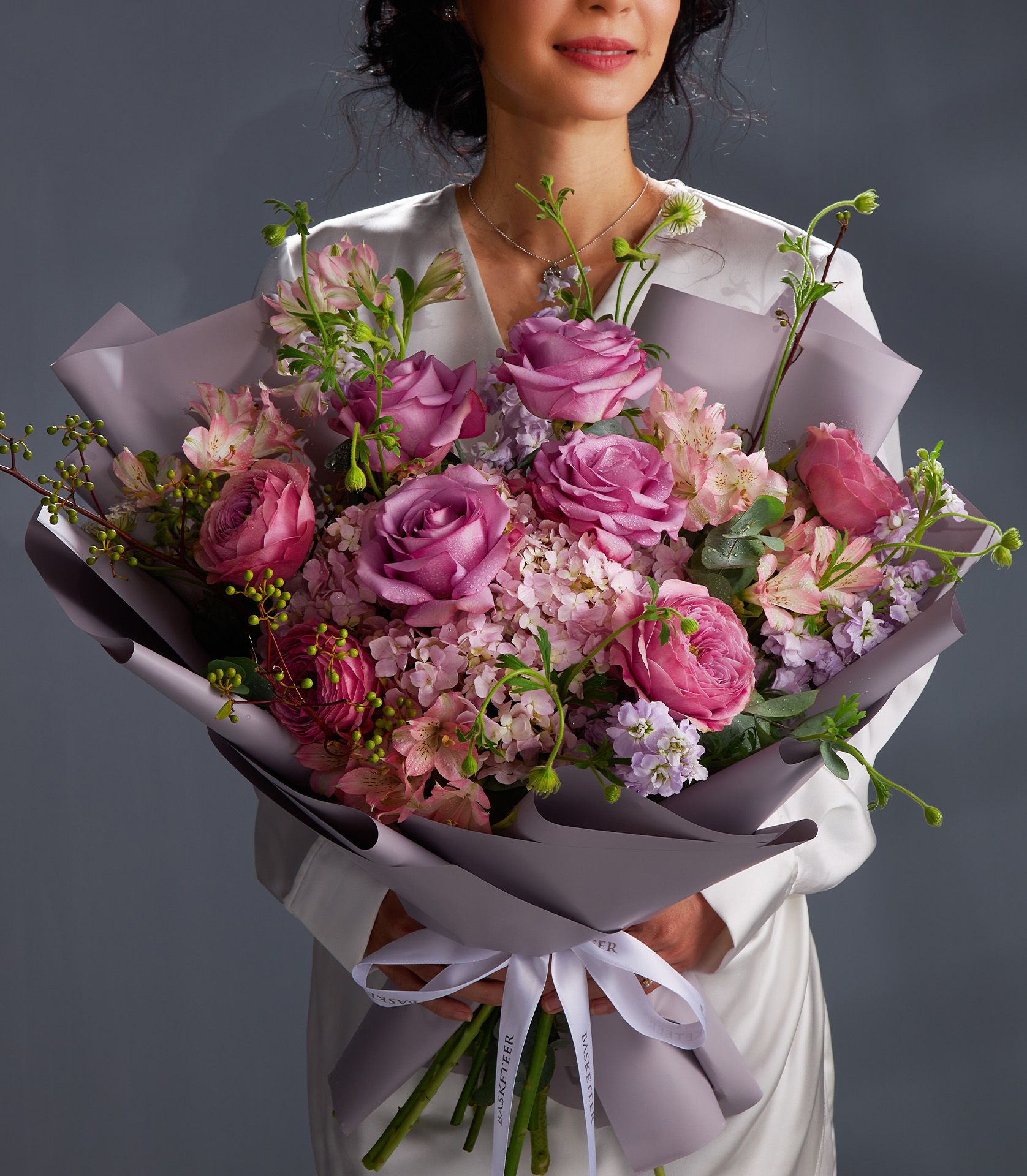 Luxury mauve and blush rose bouquet with hydrangea and alstroemeria, wrapped in lavender paper with white satin ribbon