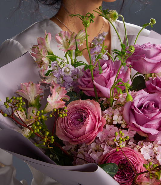 Luxury mauve and blush rose bouquet with hydrangeas and alstroemeria, wrapped in soft purple paper