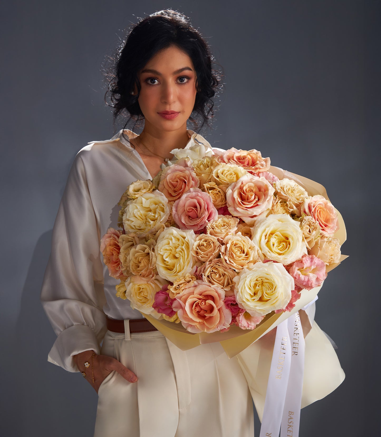 Cream and blush rose bouquet with white ribbon, perfect for anniversaries and romantic occasions