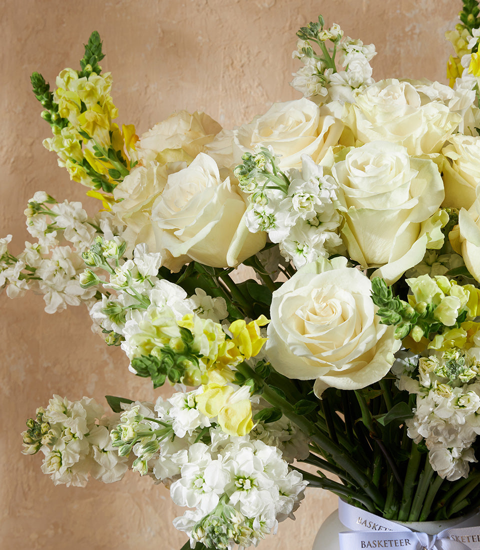 Ivory Serenity vase arrangement with white roses and white-yellow snapdragons, premium fresh flower gift