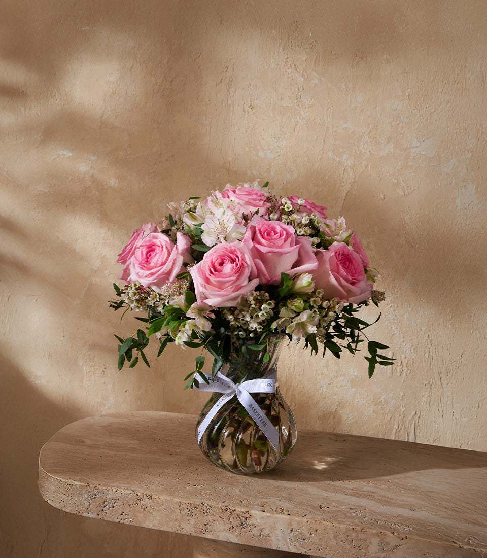 Premium pink roses and white alstroemeria in ribbed glass vase with white ribbon, luxury gift bouquet