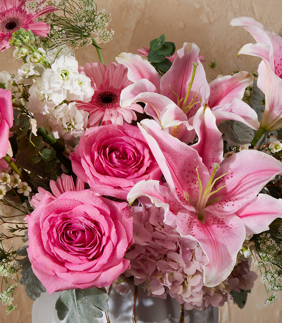 Pink and white fresh flower vase arrangement with roses, stargazer lilies, hydrangeas, and stock flowers
