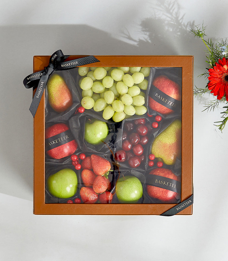 Premium assorted fresh fruit gift box with grapes, apples, pears, strawberries and cherries in luxury leather compartments