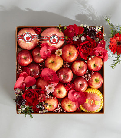 Red apples and roses luxury birthday gift box with fresh orchids and flowers