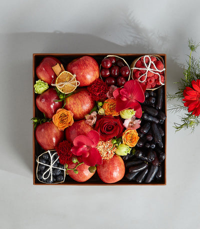 Premium Japanese melon and rose birthday gift basket with fresh red apples, berries, grapes, and orchids in wooden box