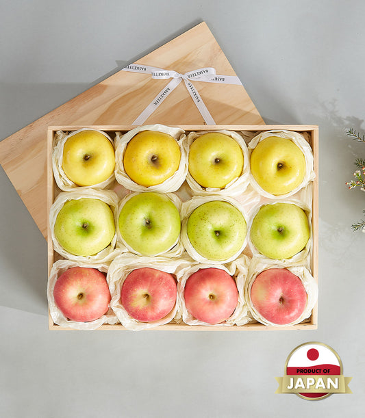 Premium Japanese apple selection box with yellow, green, and red apples in wooden gift case