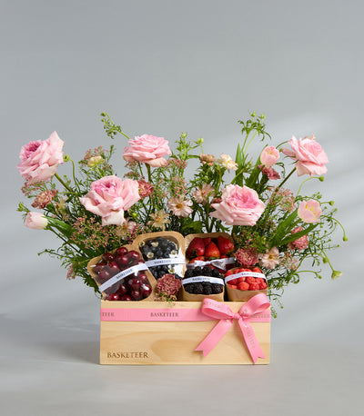 Pink rose and mixed berry luxury gift basket with fresh fruit and flowers in wooden box