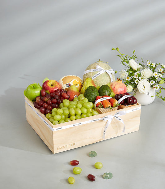 Luxury mixed fruit wooden crate with grapes, apples, pears, and berries, wrapped in Basketeer ribbon