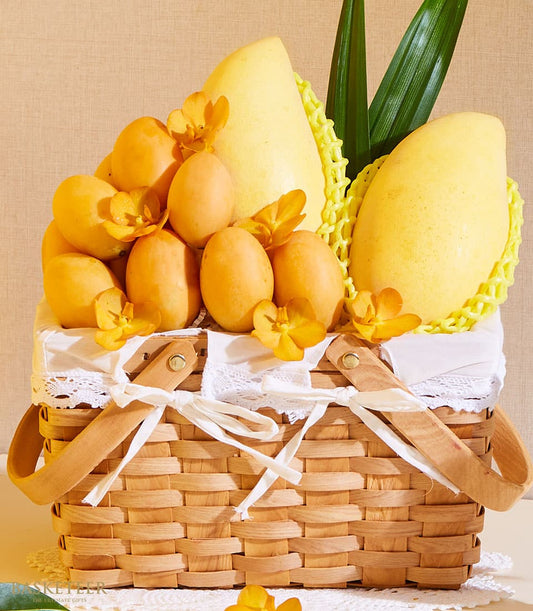 Golden mango and marian plum gift basket with orchids, woven wood handles, white ribbon bow