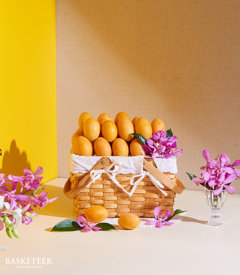Premium marian plum tropical fruit basket with purple orchids and woven handles