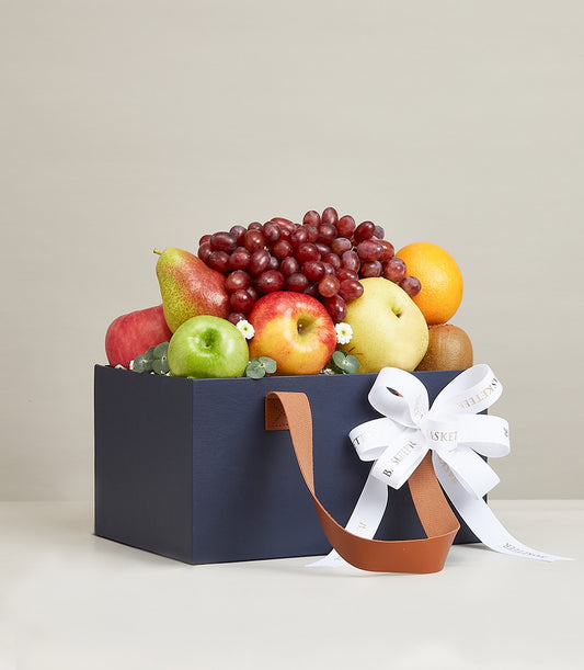 Epicurean Orchard Fruits luxury gift basket with red apples, pears, grapes, and fresh citrus in navy box