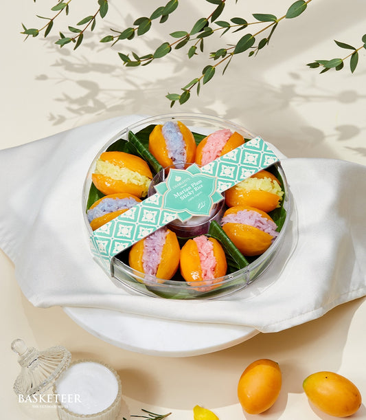 Colorful Marian plum halves filled with vibrant sticky rice in yellow, blue, pink, and purple in clear gift container