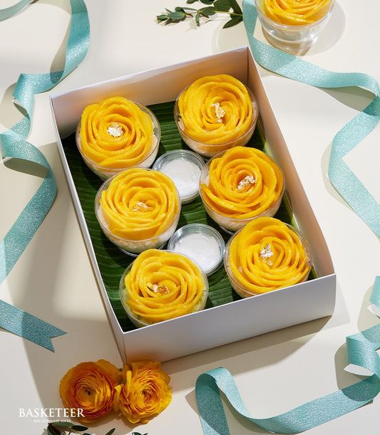 Flower-shaped mango sticky rice gift set with gold leaf, coconut cream, and tropical presentation