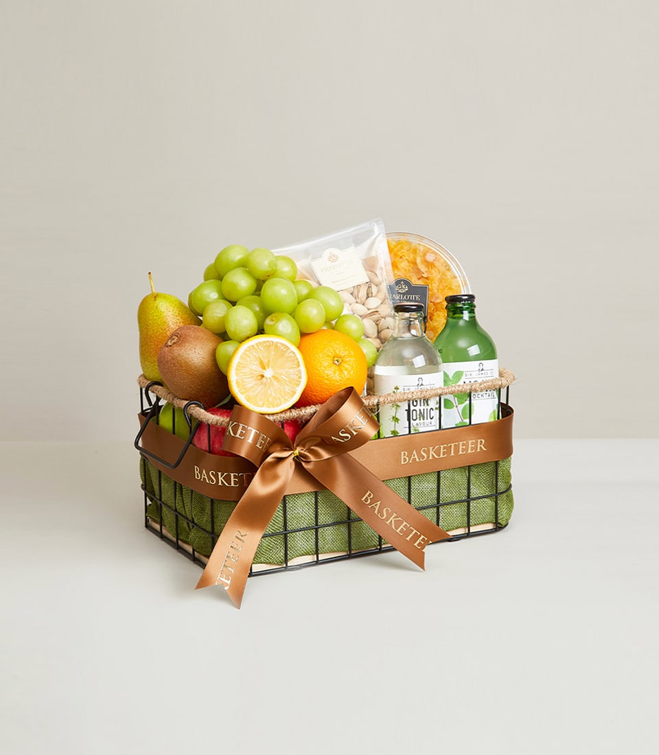 Premium black wire fruit basket with green grapes, pear, kiwis, orange, pistachios, and wellness products tied with brown