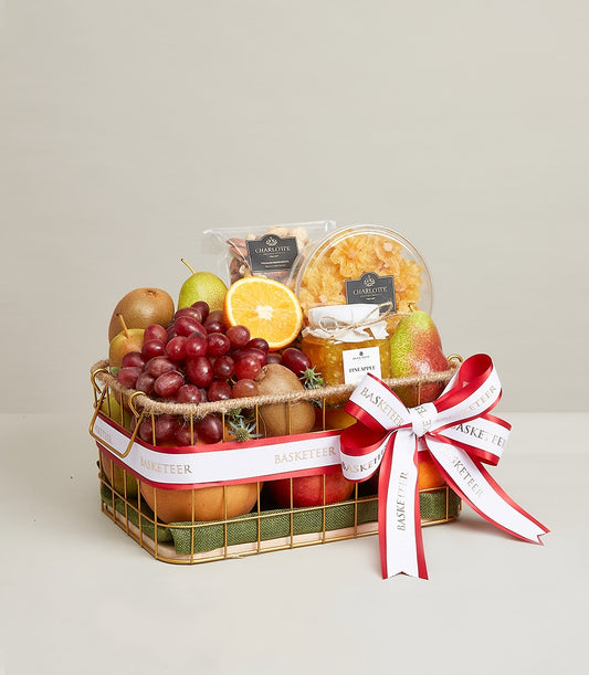 Gold wire wellness fruit basket with fresh kiwis, pears, grapes, and gourmet preserves