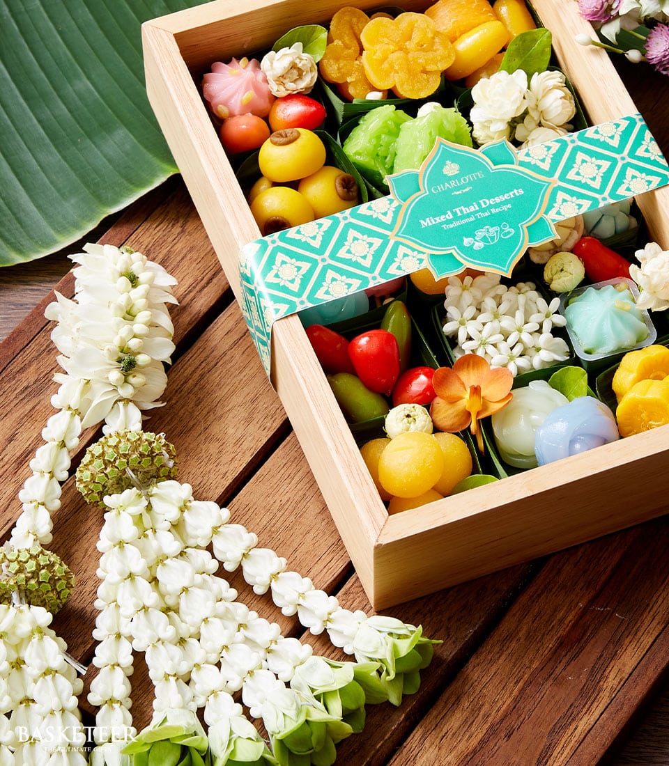 Colorful Thai dessert gift box with traditional sweets in leaf cups, Songkran new year presentation