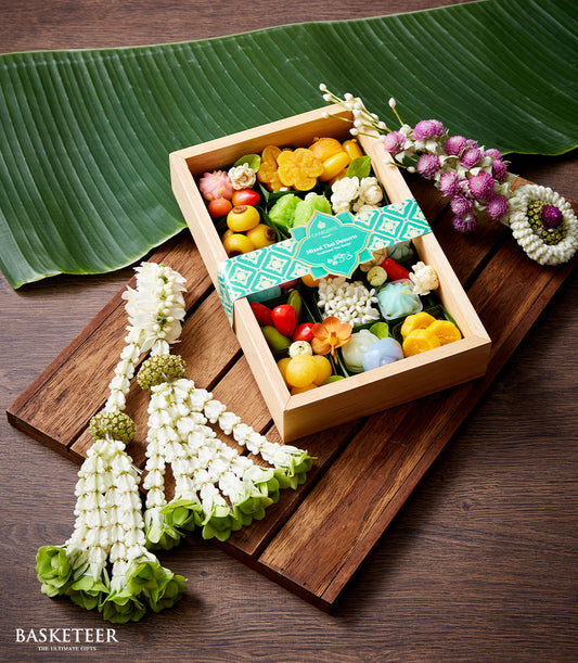 Mixed Thai dessert gift box with colorful traditional sweets in wooden case, teal ribbon, Songkran New Year presentation