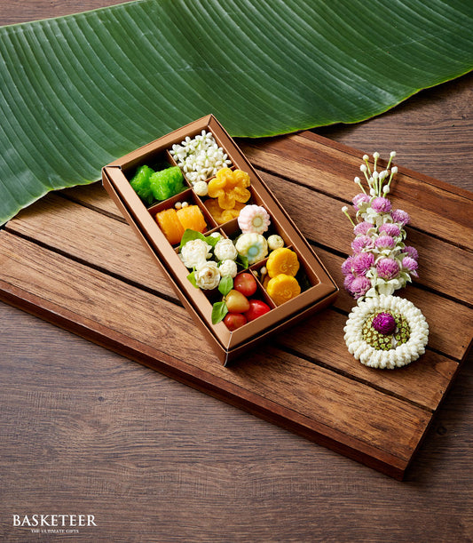 Metallic bronze gift box with assorted Thai sweets and jasmine flowers for Songkran celebration