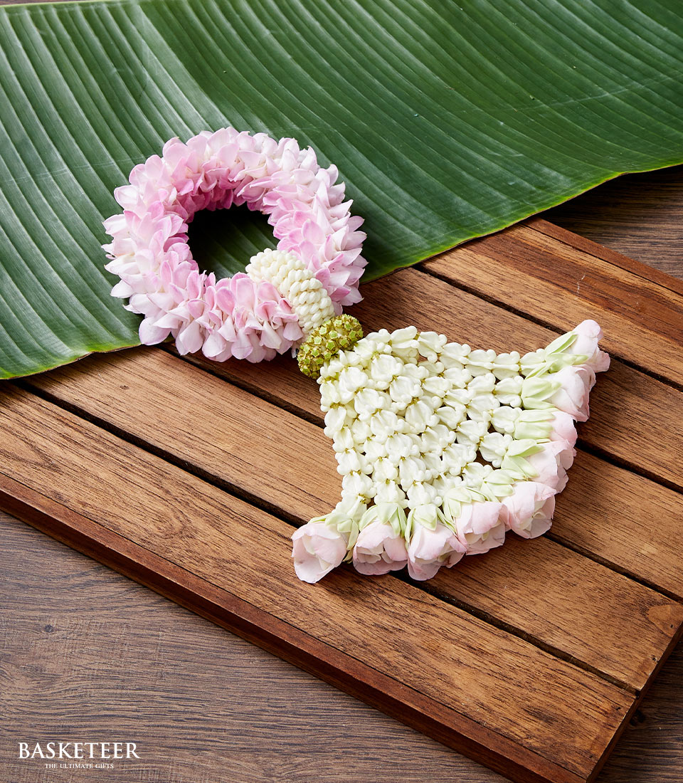 Pink jasmine and rose petal Thai garland with cascading white buds, traditional Songkran celebration flower gift