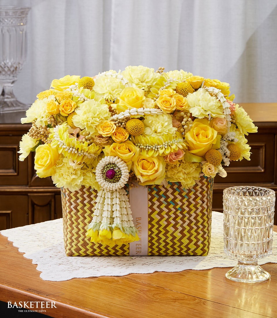Yellow Thai flowers basket with roses and carnations, traditional garland for Songkran New Year celebration