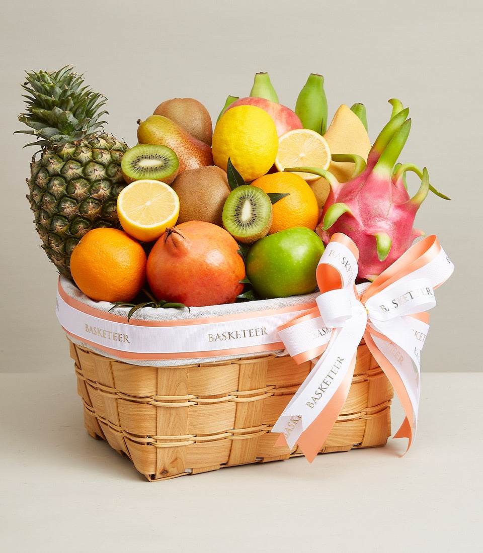 Regal Fruit Gift Basket with pineapple, pomegranate, kiwi, and dragon fruit in woven wood basket
