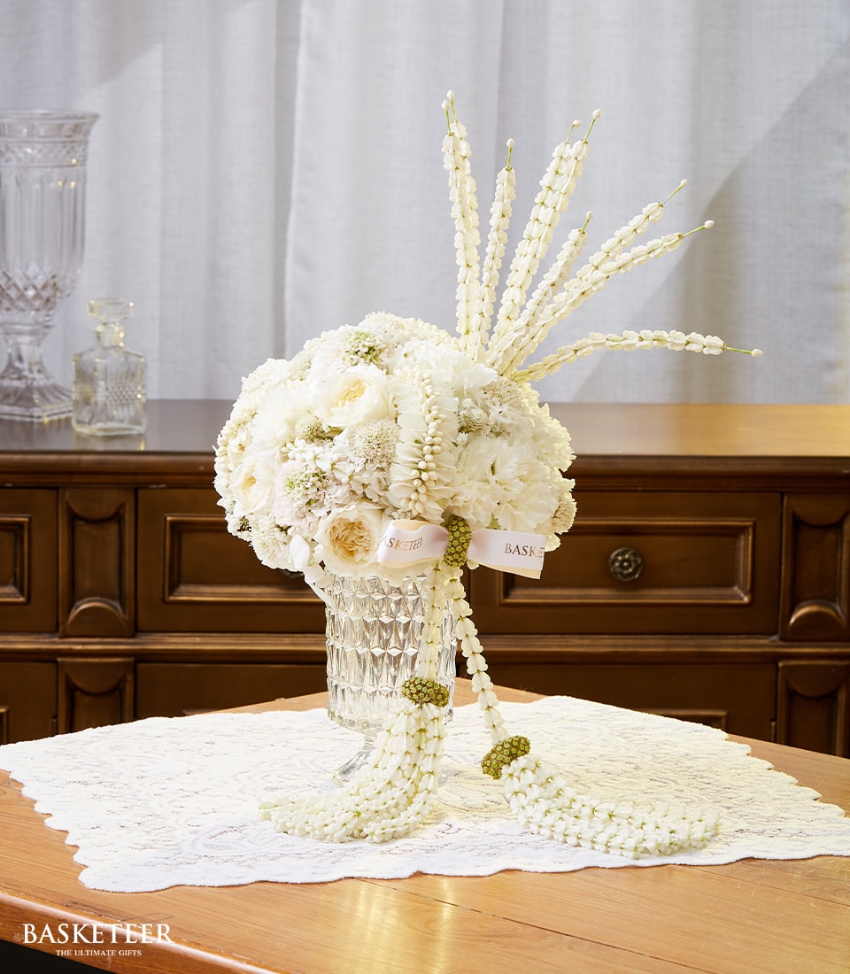 Premium white roses and jasmine Songkran centerpiece in crystal vase with cascading garland