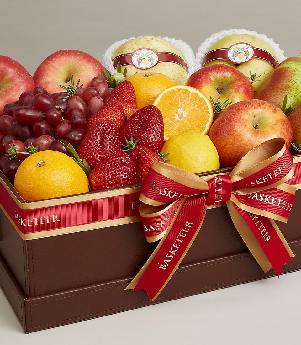 Luxury dark brown leather fruit gift box with red and gold Basketeer ribbon, filled with fresh apples, grapes, strawberries,