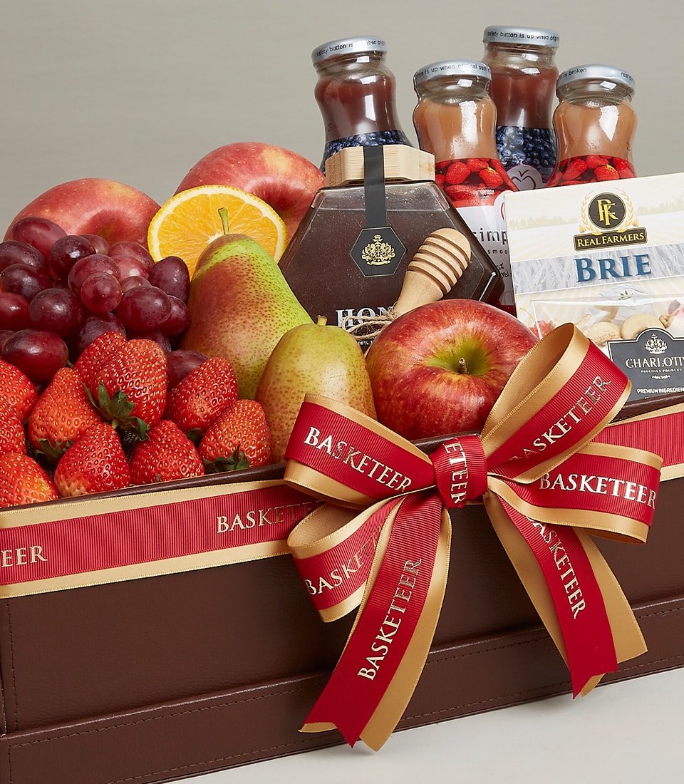 Luxury fruit and gourmet gift basket with fresh apples, pears, strawberries, artisan cheeses, preserves and honey in