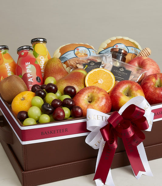 Premium wellness gift basket with fresh fruit, juices, honey, and artisan nuts in leather-style hamper
