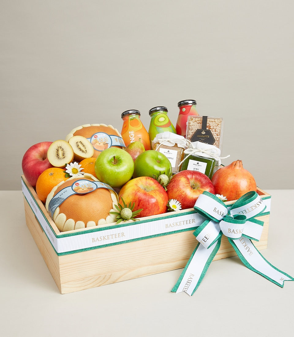 Premium wooden fruit crate with fresh apples, oranges, pears, artisan juices and preserves gift box