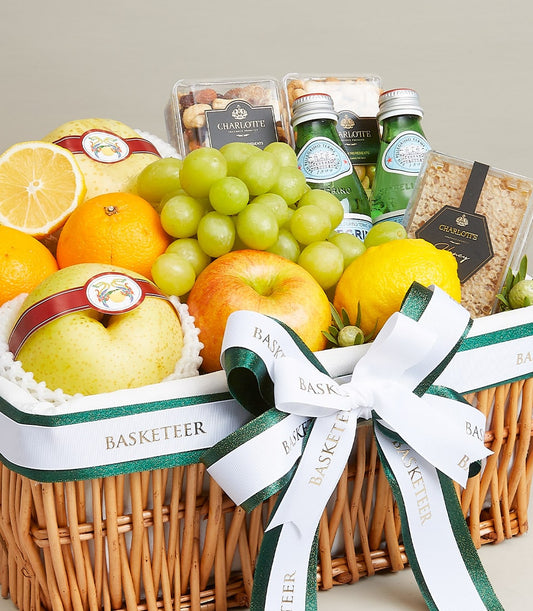 Wicker gift basket with fresh grapes, oranges, lemons, pears, apples, gourmet nuts, sparkling water, and honeycomb