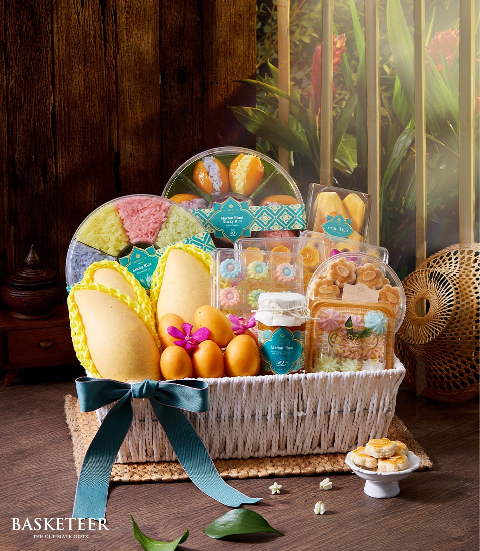 Premium Thai sweets and mango gift basket with orchid, teal ribbon, and pastel treats for Songkran