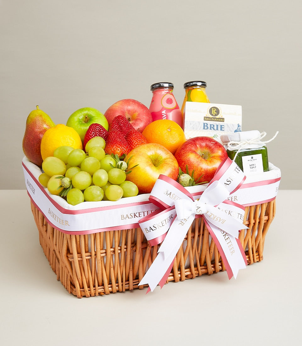 Vibrant fruit and brie celebration basket with fresh apples, pears, oranges, strawberries, grapes, gourmet cheese and