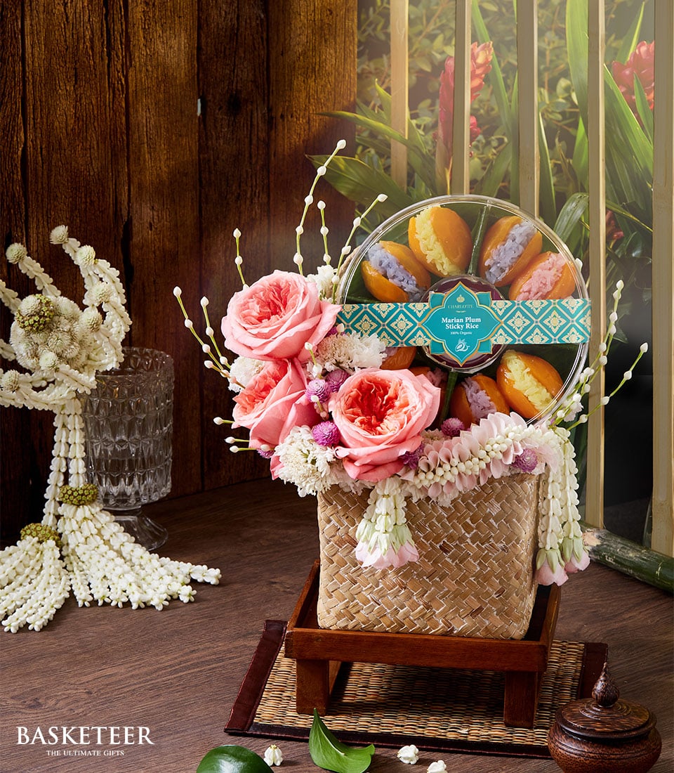 Pink rose and purple flower arrangement with Marian Plum sticky rice, Thai garland, woven basket gift for Songkran