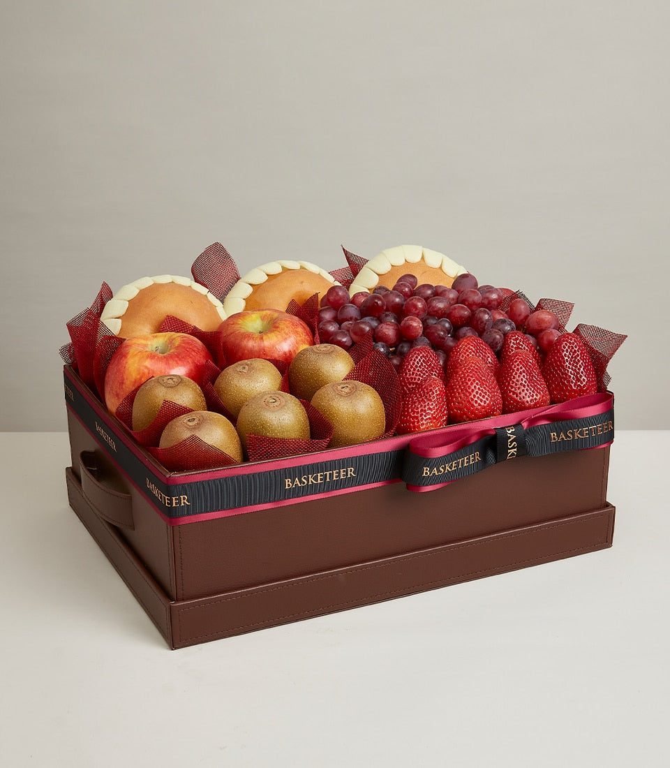 Premium fresh fruit gift box with apples, kiwis, grapes, and strawberries in luxury brown leather-style case