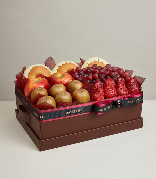 Premium fresh fruit gift box with apples, kiwis, grapes, and strawberries in luxury brown leather-style case