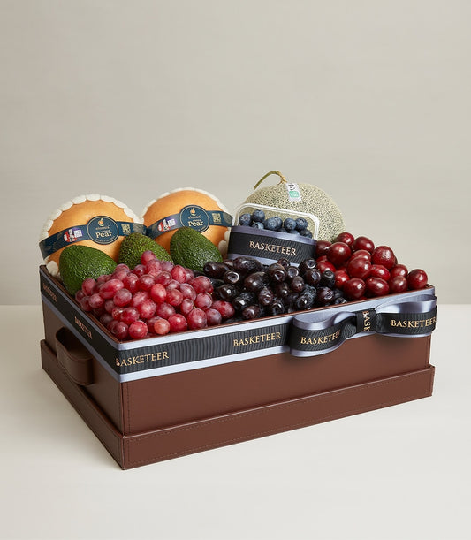 Luxury fruit selection box with pears, avocados, grapes, cherries, blueberries and melon in faux leather presentation case