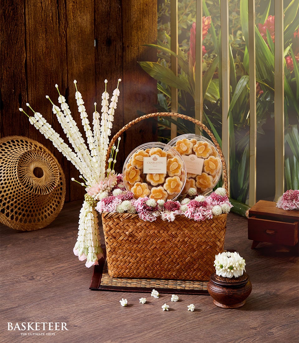 Pink and white flower-trimmed almond cookie gift basket for Songkran Thai New Year celebrations
