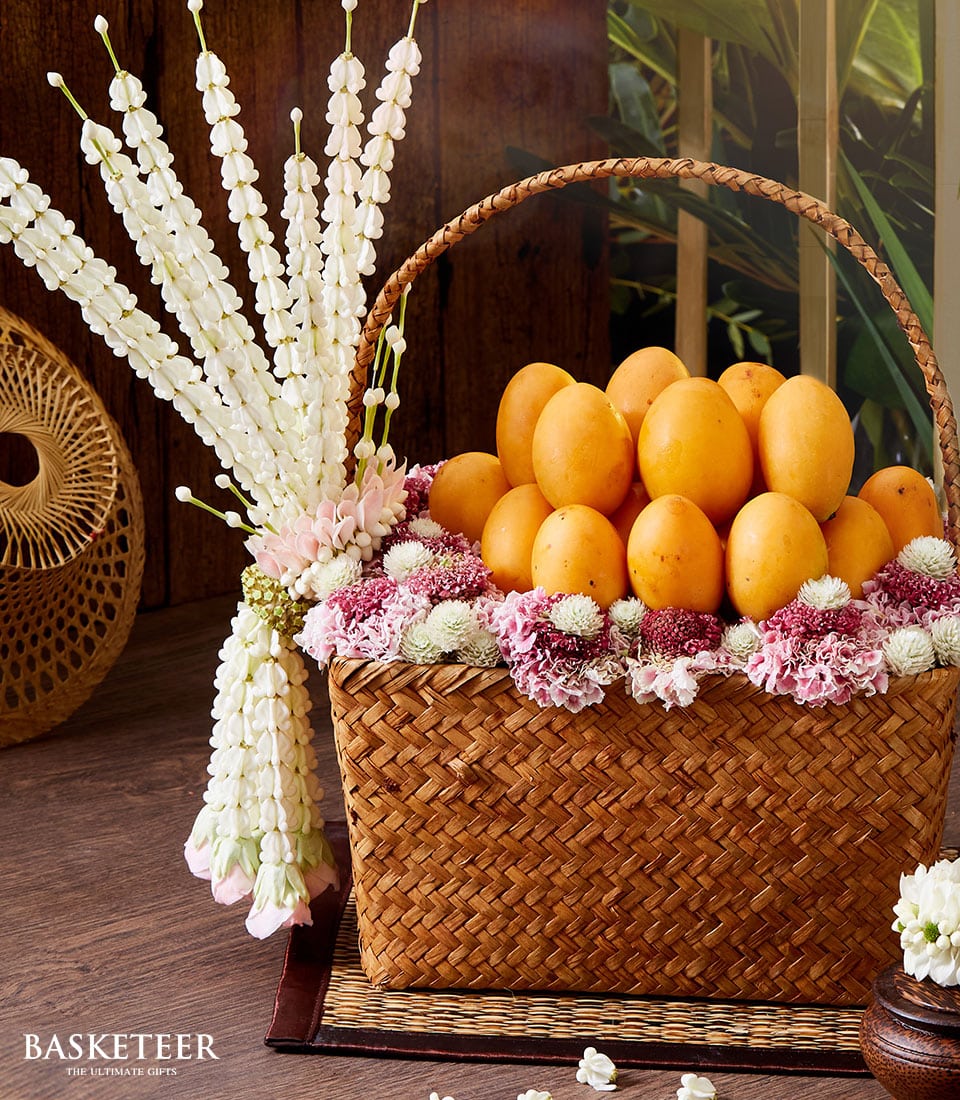 Thai Marian plum gift basket with fresh fruit, pink and red flowers for Songkran celebration